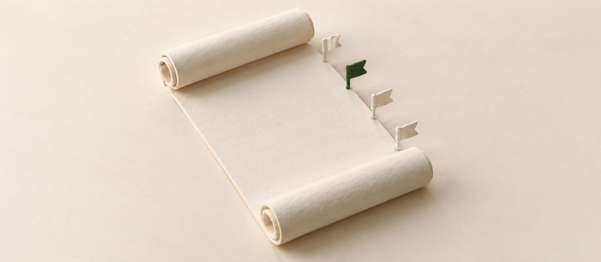 A cream study model of a partly unrolled blank contract scroll with four small pin flags stuck along its edge, with one of the flags in green.