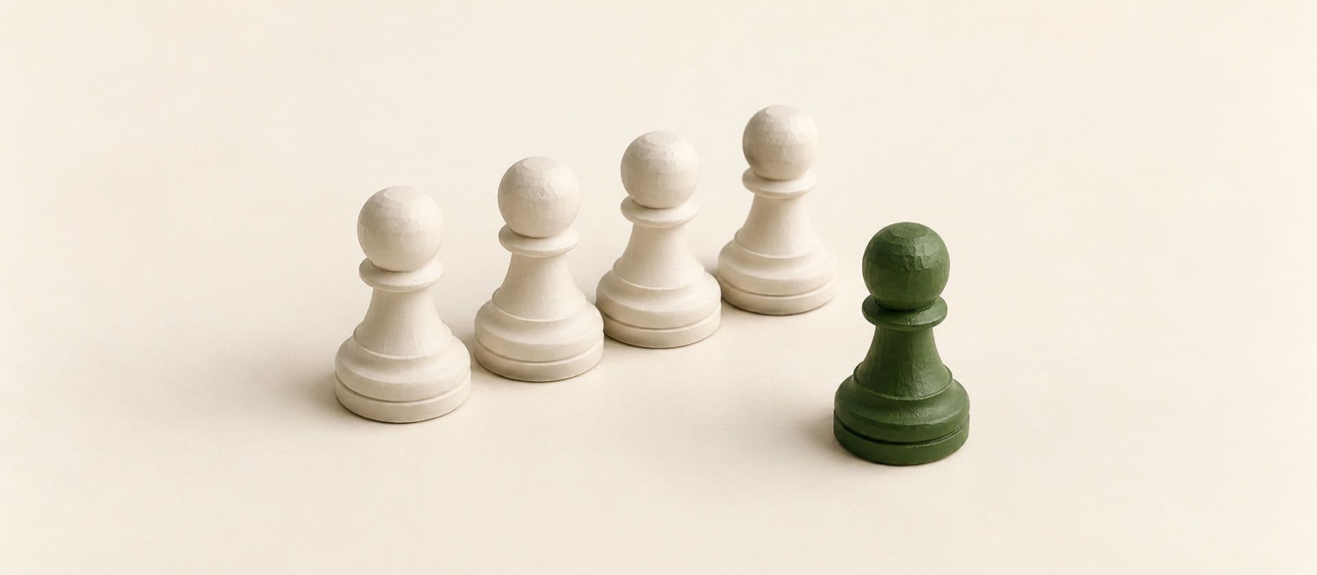 A cream study model of a row of five identical chess pawns, one stepped a square ahead of the others, with the pawn that is ahead in green.